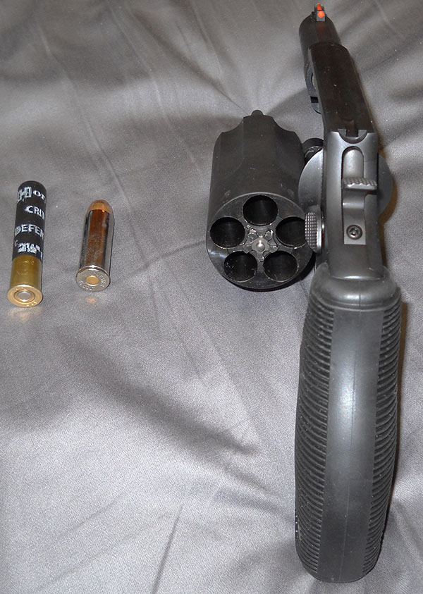 Taurus The Judge, cylinder open, with .45 LC and .410 cartridges